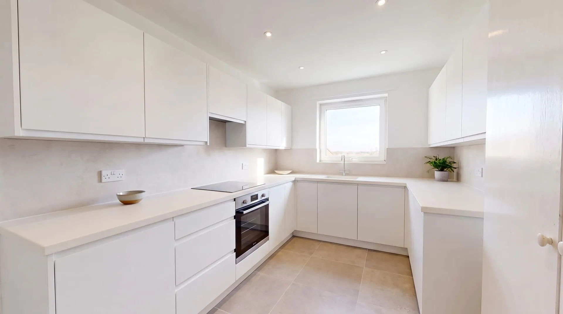 The same white kitchen with seamless matte white solid surface countertops