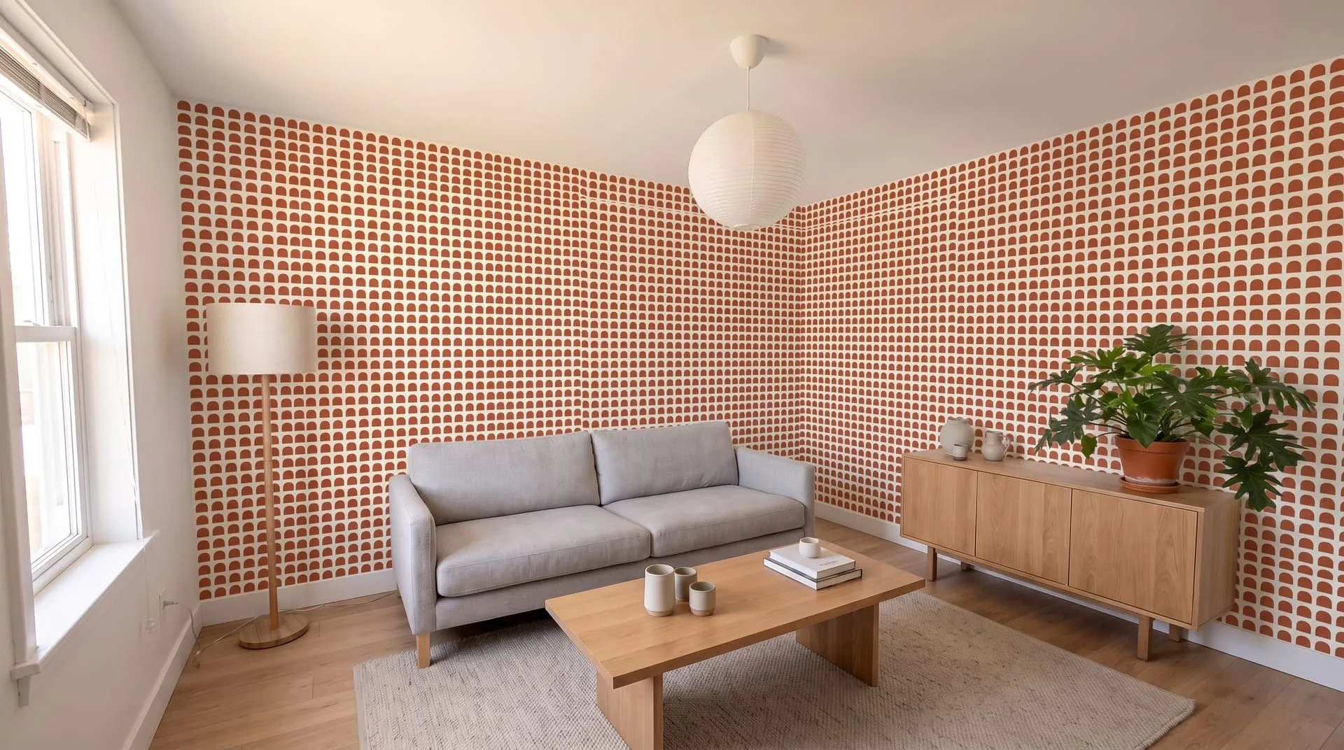 The same living room with a small terracotta arch pattern wallpaper on two walls