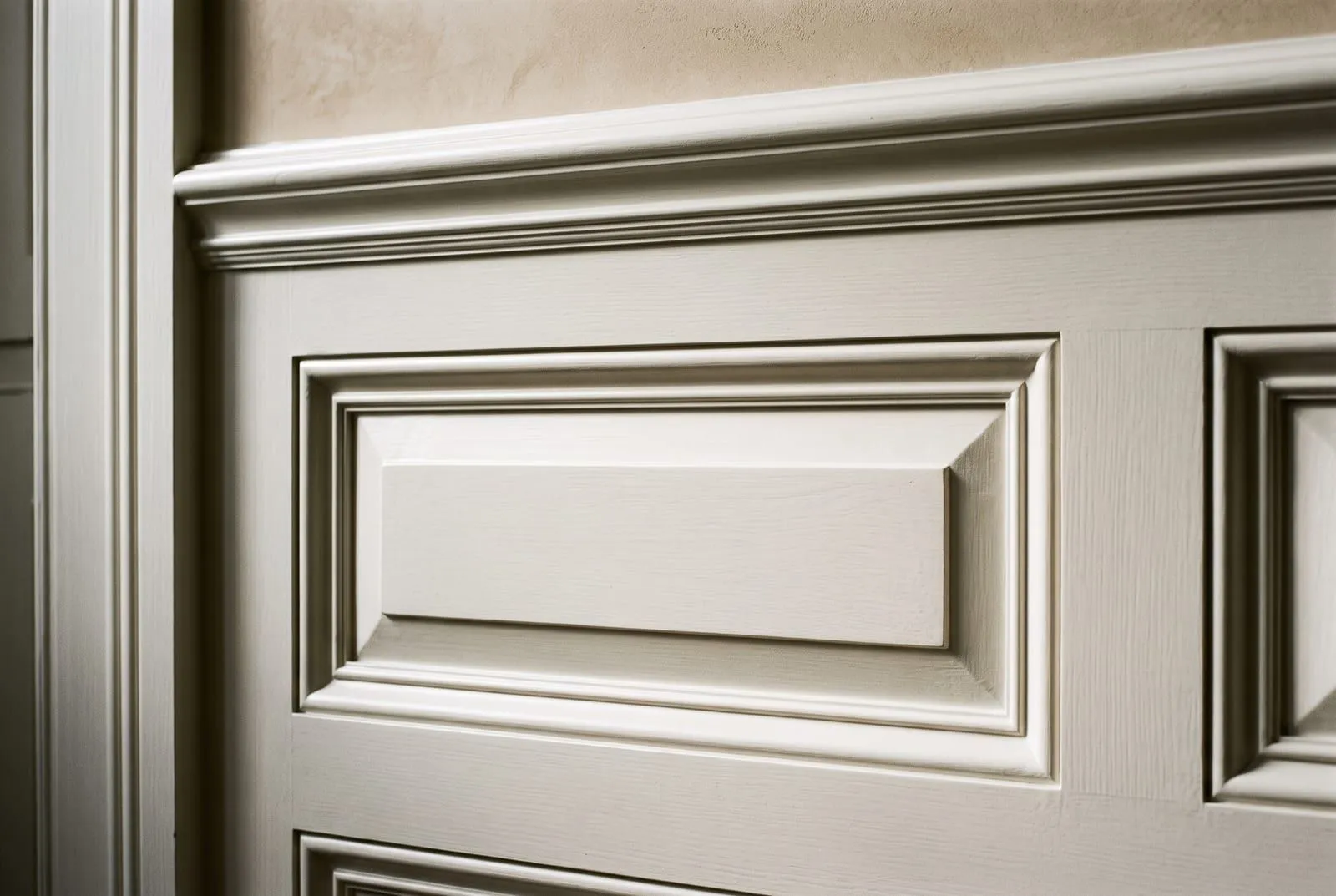 Close-up of raised-panel wainscoting with bevelled panel and moulded chair rail